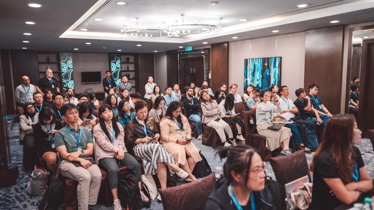 A packed room of attendees listening to a session at an AIS conference